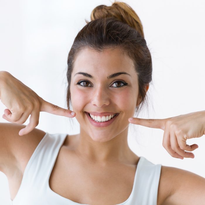 Happy patient pointing at her smile